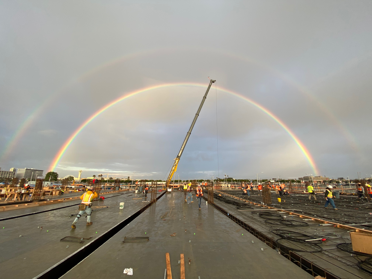 A double rainbow shines as the first upper level deck for the Intermodal Transportation Facility