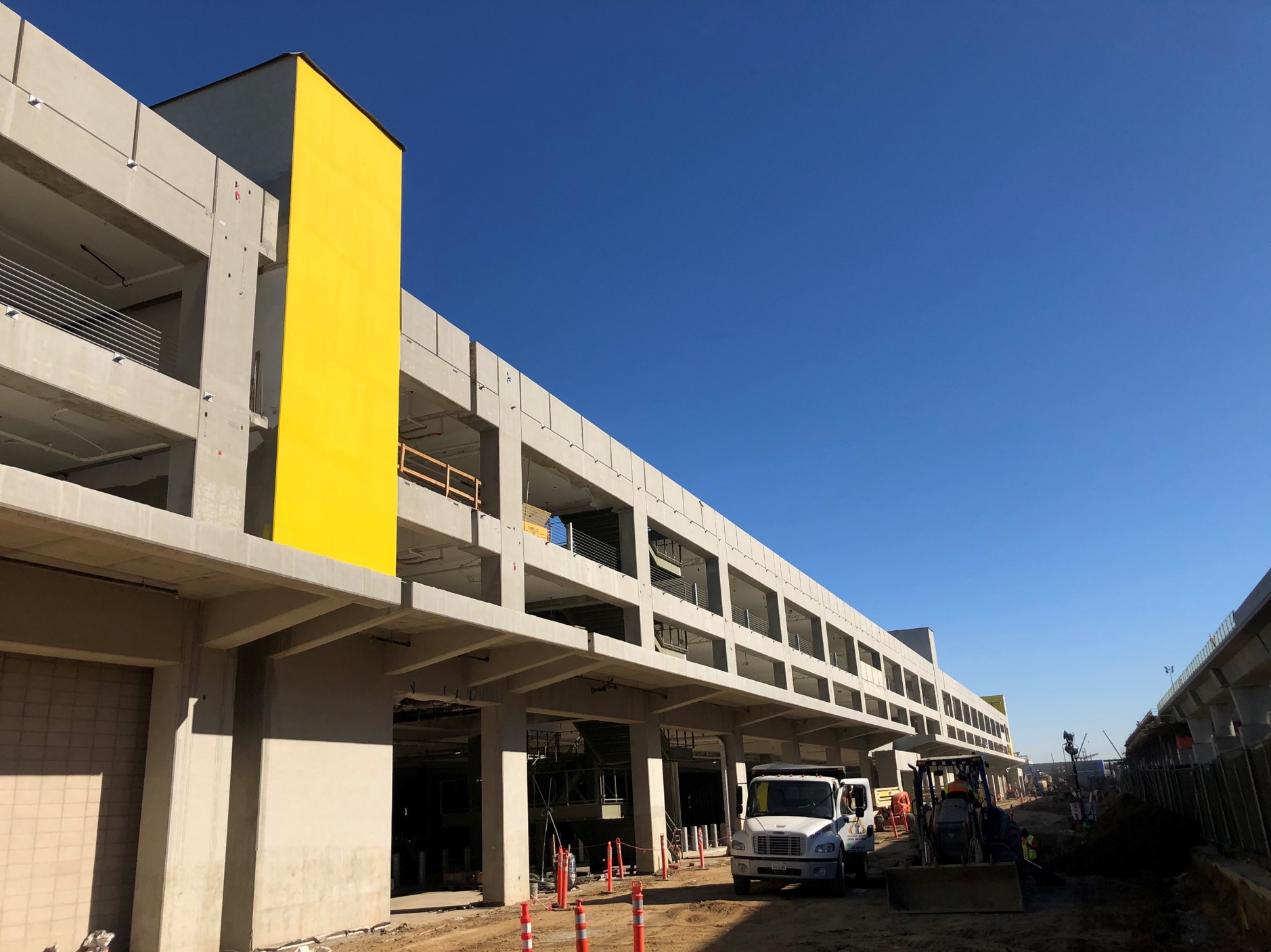 The south side of the Intermodal Transportation Facility-West and an elevator core (yellow).