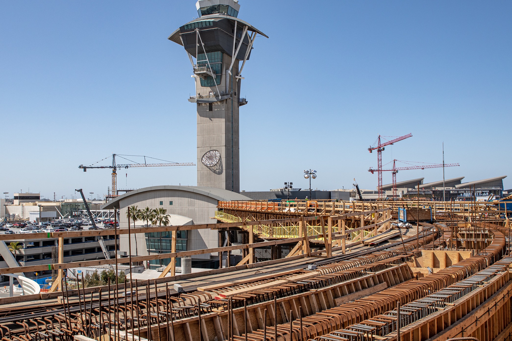 The APM guideway will curve around the Los Angeles International Airport Theme Building and pass by the LAX Control tower as it approaches the future Center Central Terminal Area station.