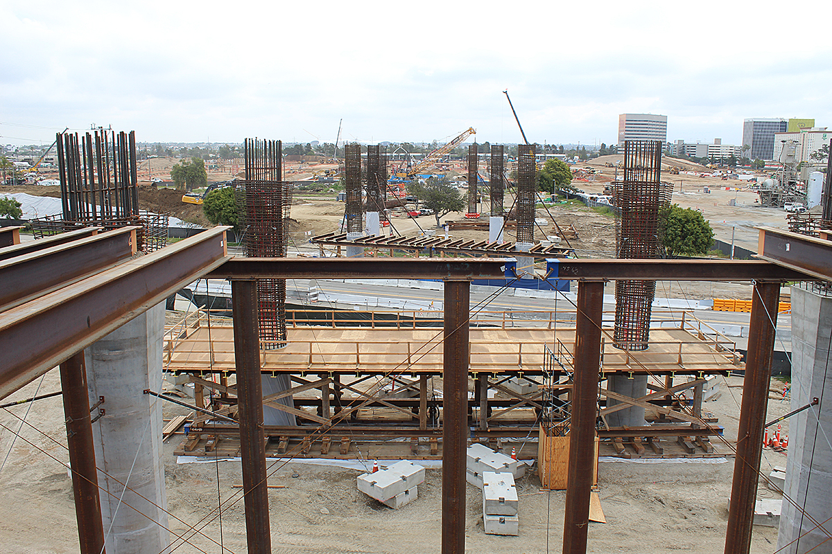 Looking out towards the future Consolidated Rental Car Facility, the guideway structure over Aviation Boulevard rises out of the ground.