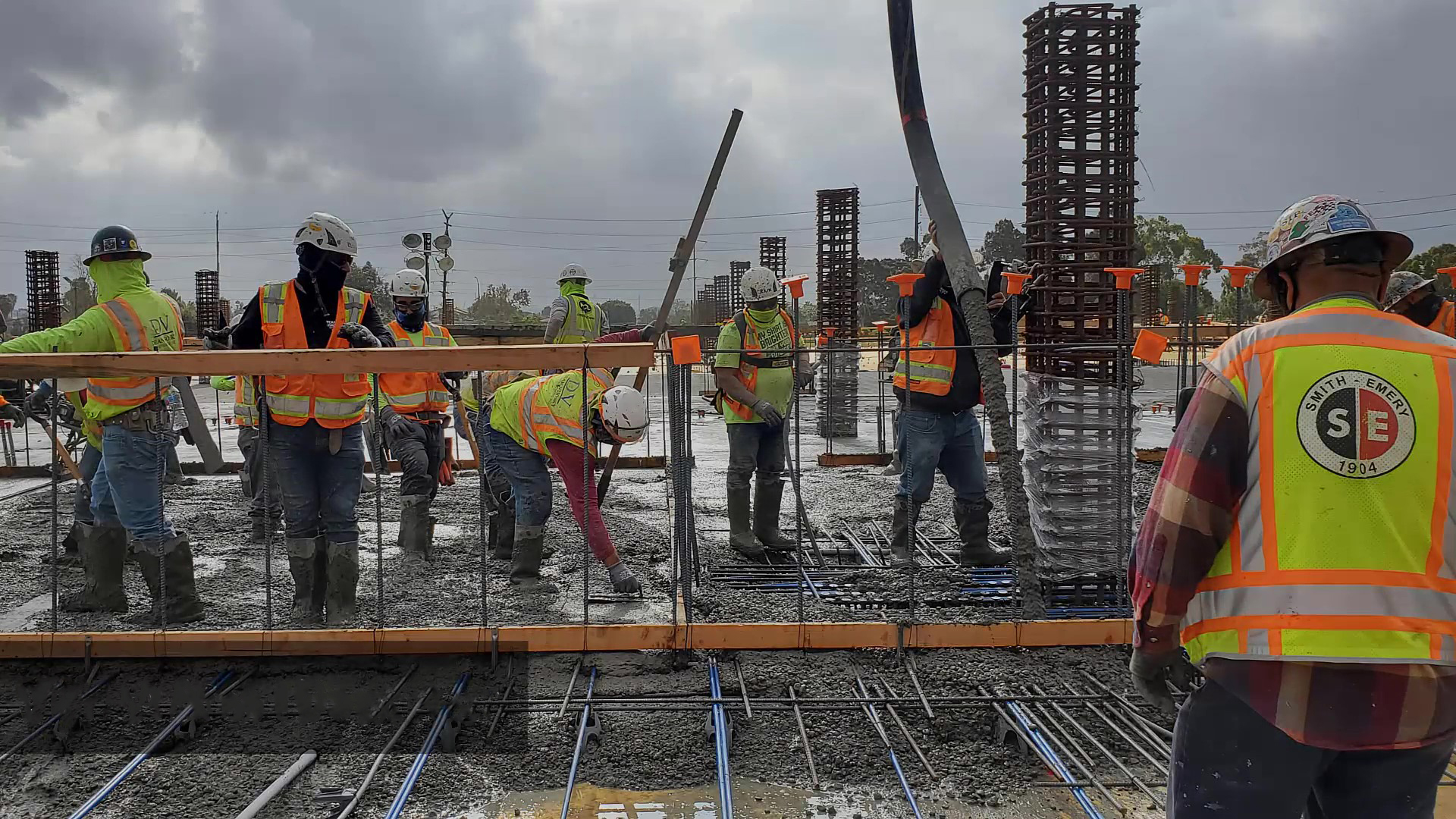 Workers pour concrete for the first elevated deck of the Quick Turn Around area at the Consolidated Rent-A-Car facility site.