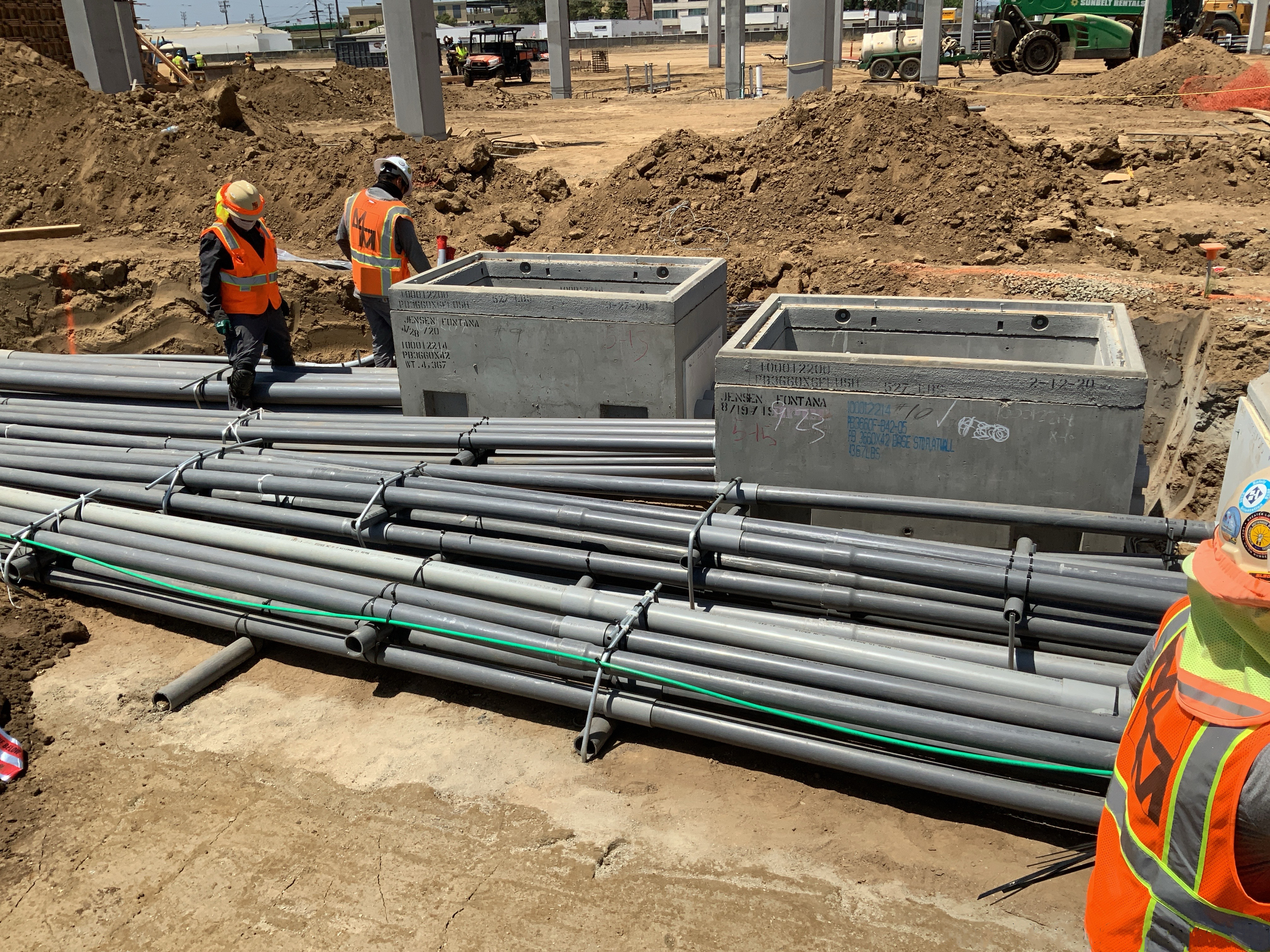 Workers at the Consolidated Rent-A-Car facility Ready Return/Idle Storage building installing the pre-fabricated duct banks that will carry wires for communications, data, low voltage and medium voltage to the rest of the building.