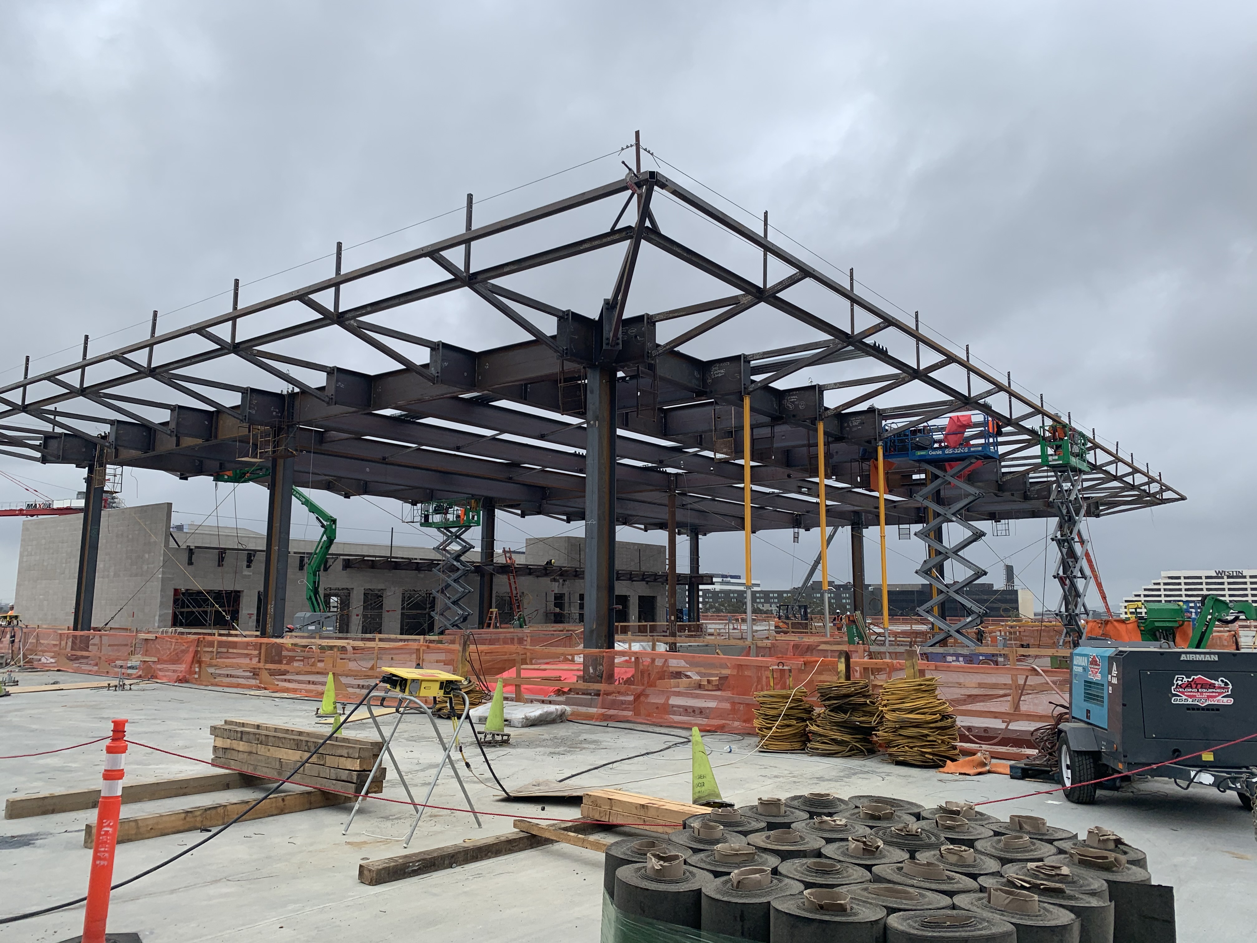 Structural steel installation for the Automated People Mover station canopy at the Consolidated Rent-A-Car facility.