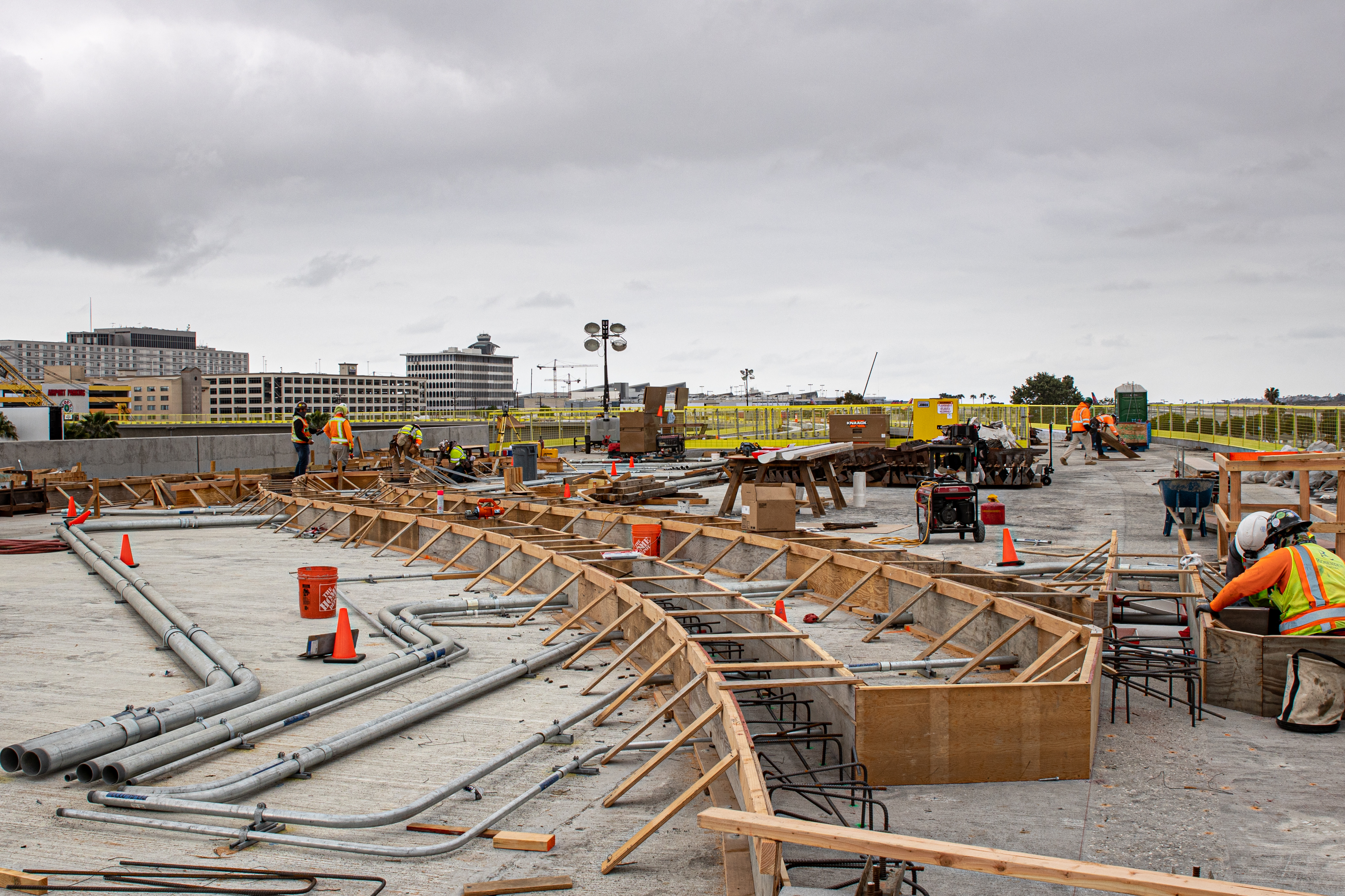 Crews construct formwork on the guideway superstructure for the system's concrete tracks.