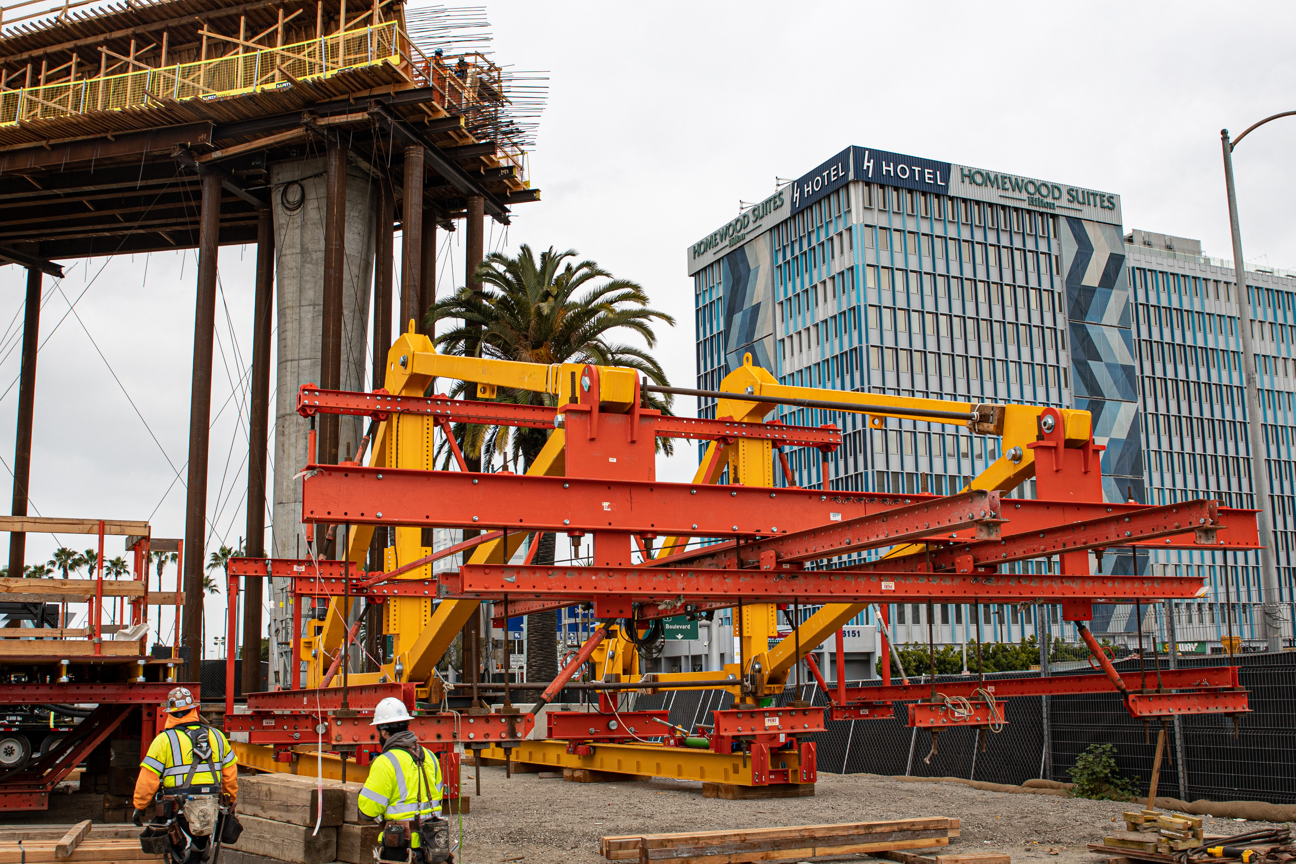 Workers assemble the form-traveler, which will be used to construct the guideway over Century Boulevard without the use of falsework.