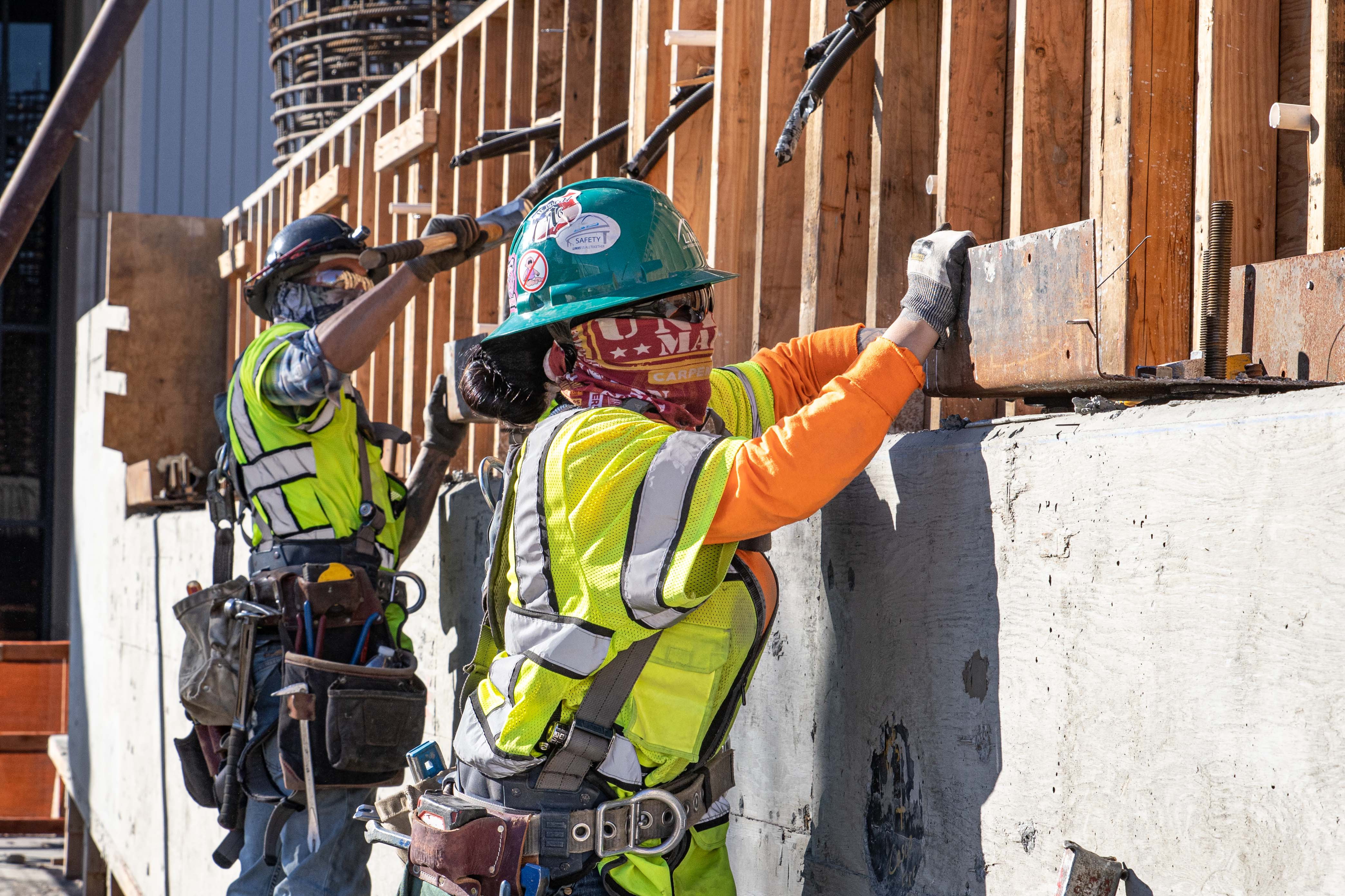 Workers remove formwork after the concrete for the station's support elements reaches prescribed strength.