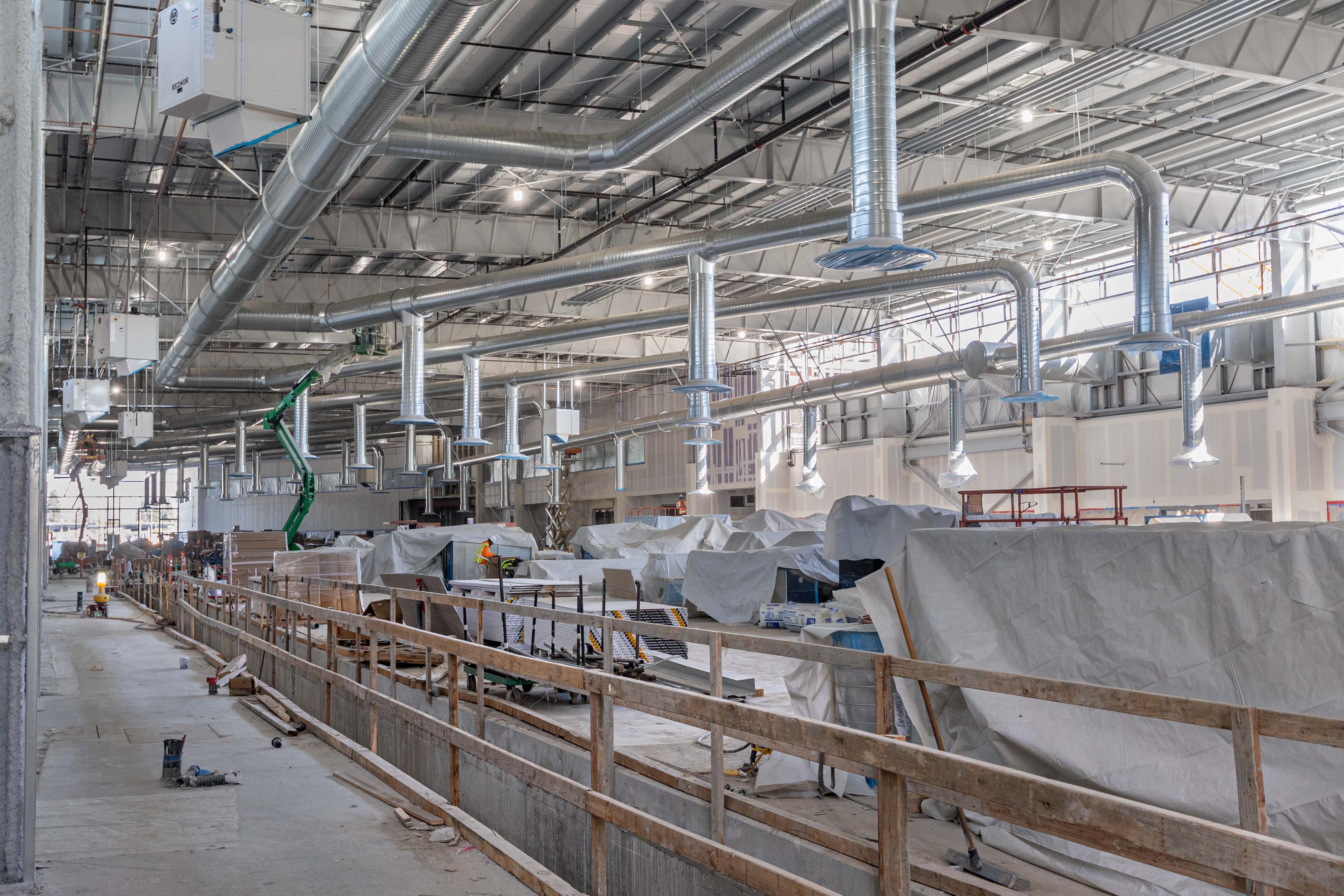 At the APM system's future Maintenance and Storage Facility, ductwork and drywall installation continues as the building interior takes shape.