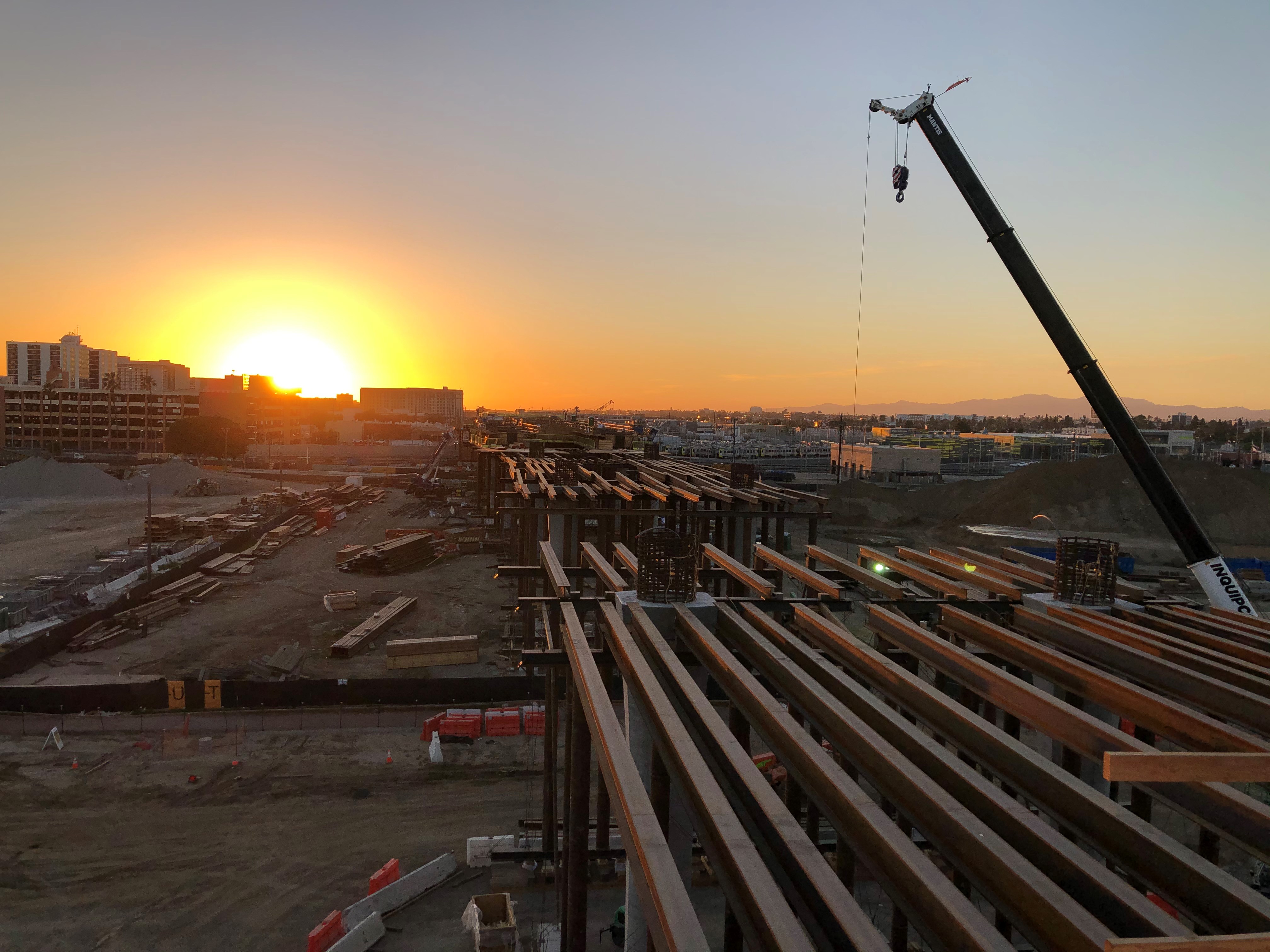 Sunset views from the roof of the Consolidated Rent-A-Car facility as the Automated People Mover train guideway falsework is constructed to connect the two.