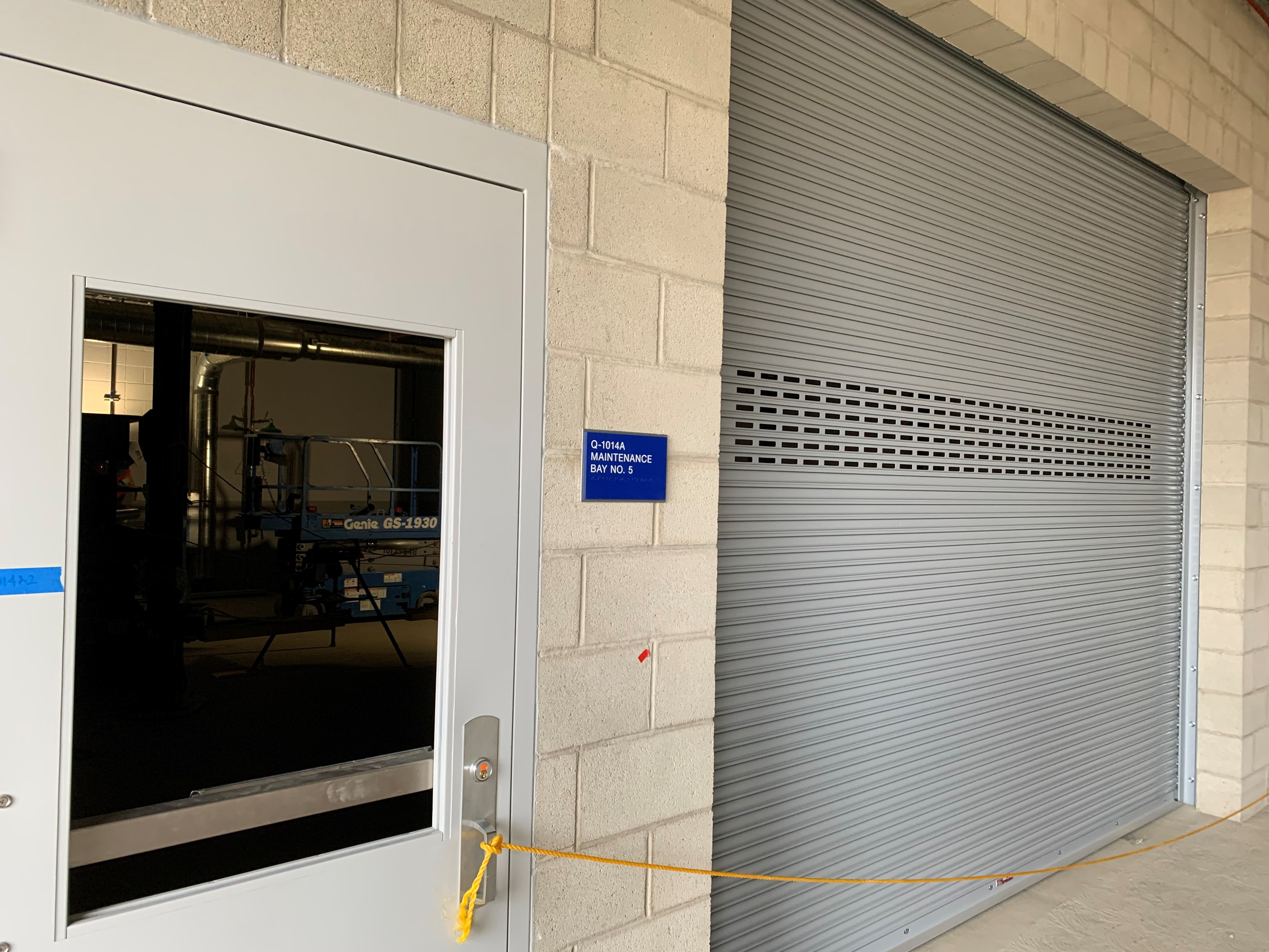 Quick Turn Around (QTA) maintenance bay door at the Consolidated Rent-A-Car (ConRAC) facility.