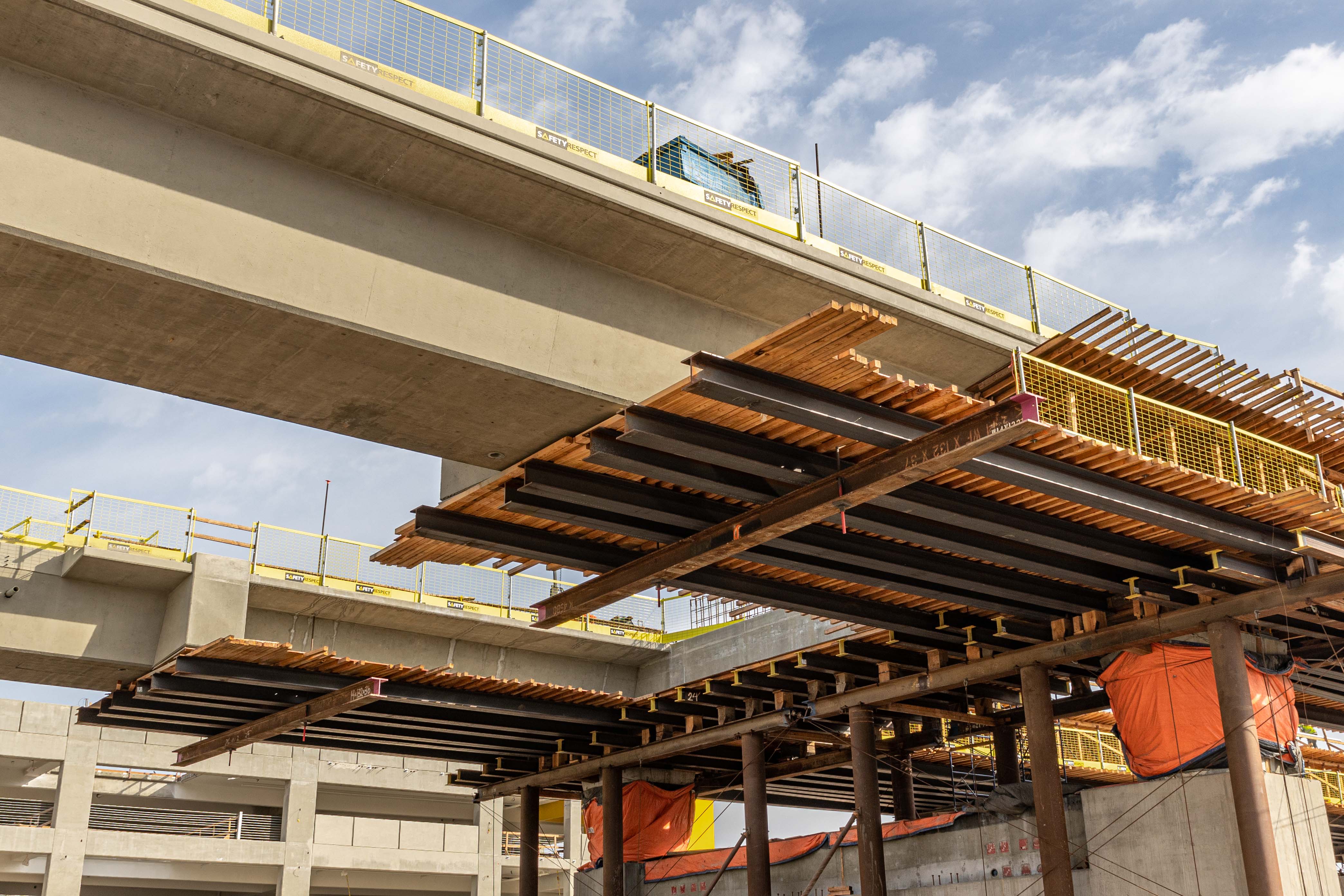 As segments of the guideway superstructure reach prescribed strength, the falsework supporting that segment is disassembled and used at other locations.