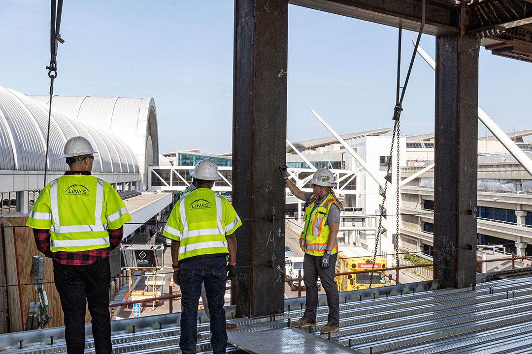 Construction oversight reviews the steel installation