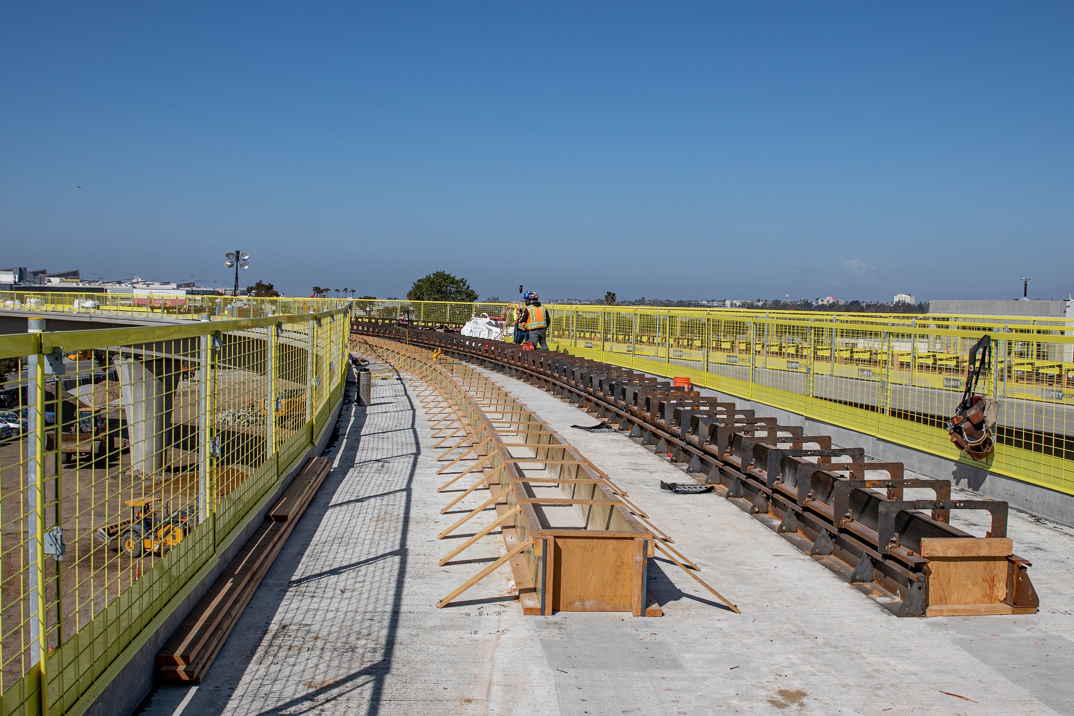 Following the completion of work constructing the guideway superstructure, work can begin on the Automated People Mover system's concrete tracks.