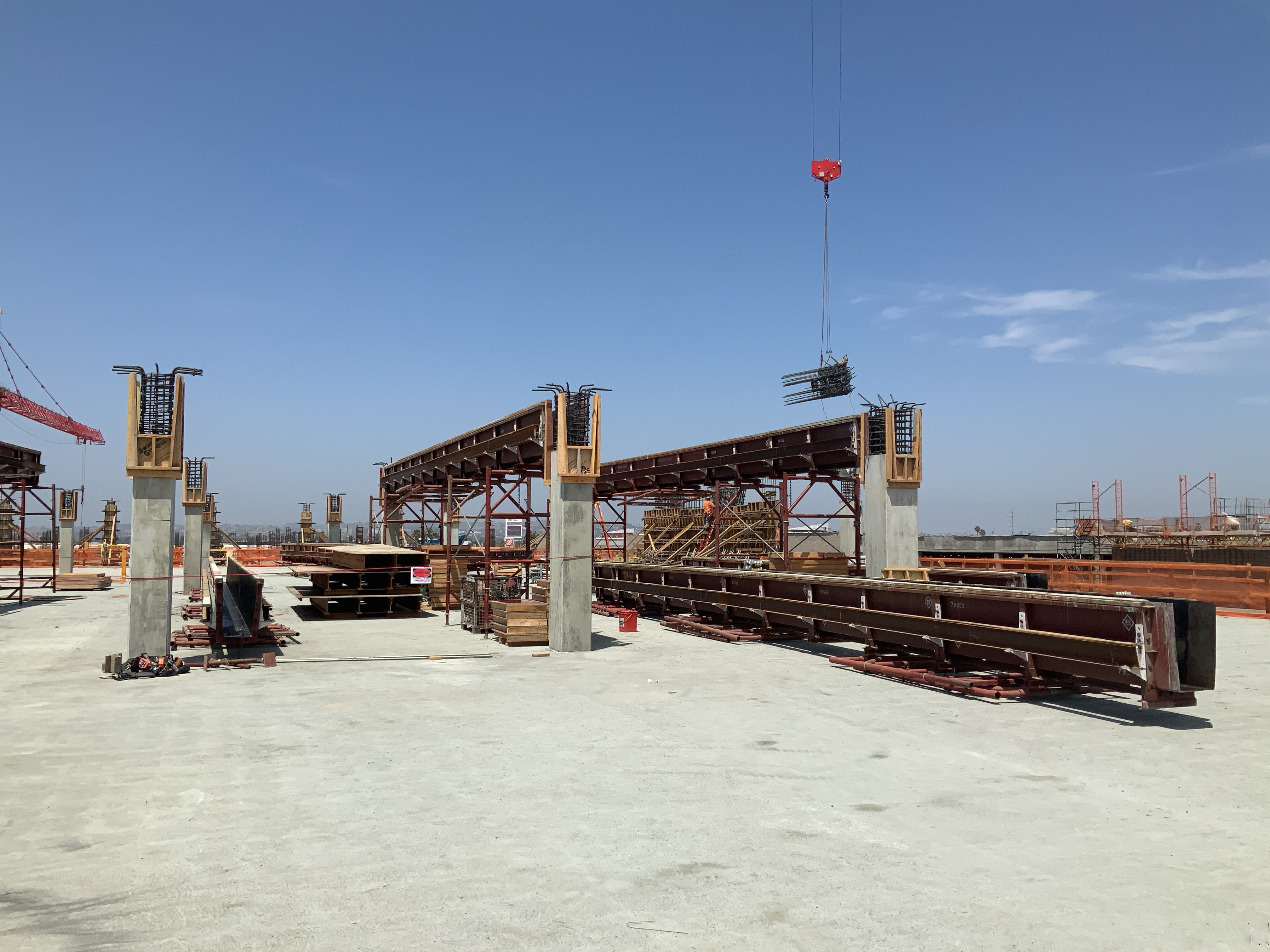 Installing beams for Idle Storage building fifth level deck pour at the Consolidated Rent-A-Car facility. 