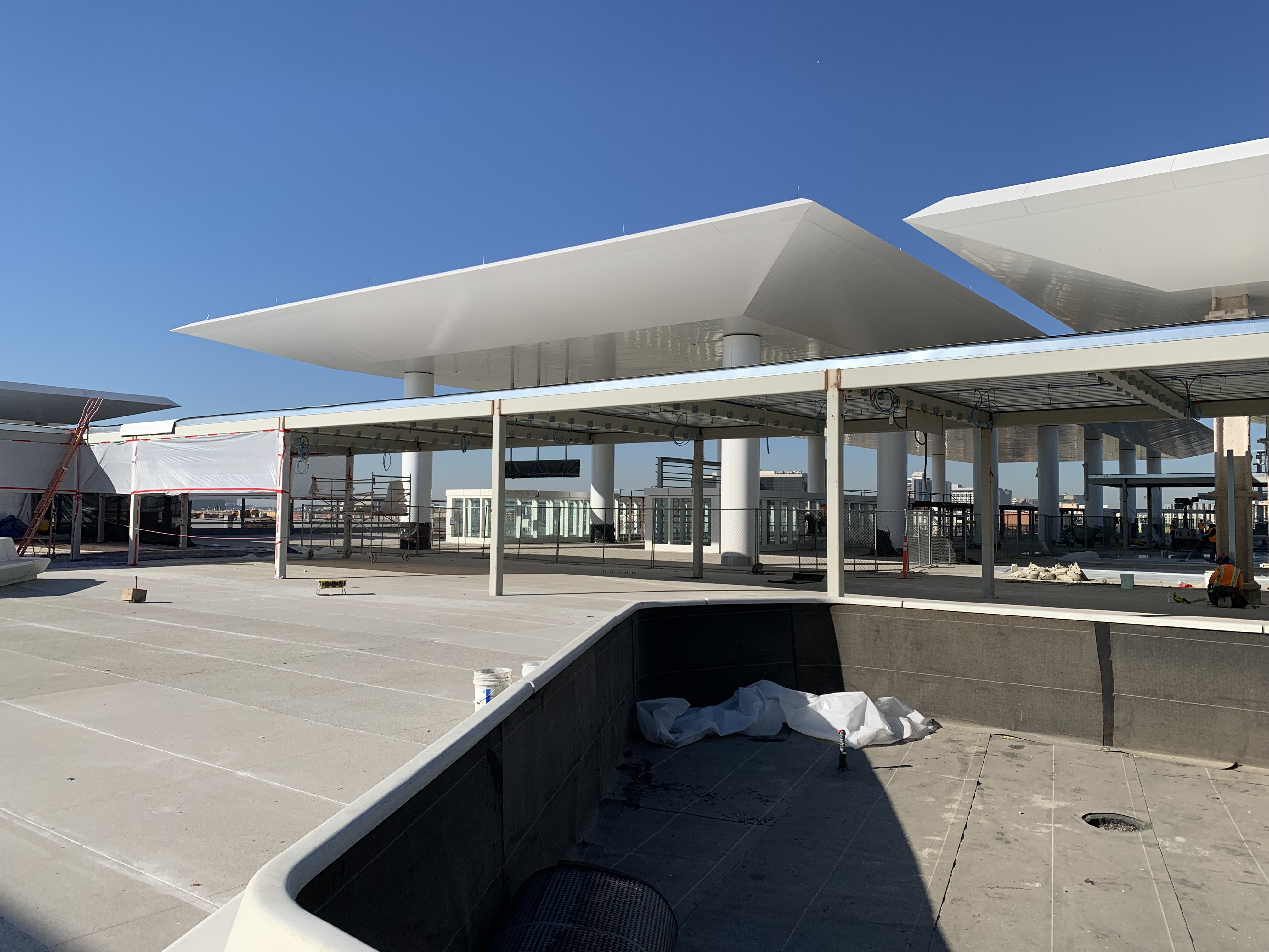 A customer service plaza precast planter bench, in front of the Automated People Mover station, on the top-level of Consolidated Rent-A-Car facility’s Ready Return building.