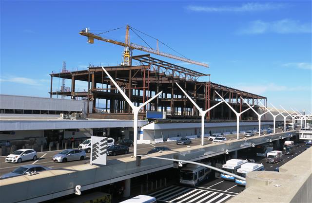 The right drop-off lane on the Upper/Departures Level is being used as a pedestrian walkway during construction of Terminal 1.5, which will connect Terminals 1 and 2.