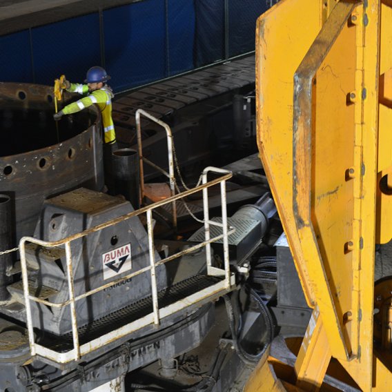 crew member measures the depth of the first cast-in-drilled-hole pile 